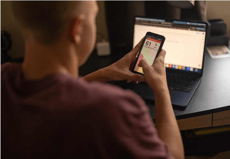 Eversense user uses Eversense 365 CGM system to manage alerts and notifications on phone